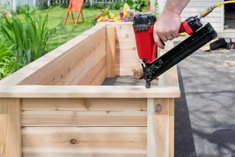 Carpenter building cedar garden planters Callyn Carpentry & Joinery Woking